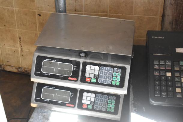 Tor-rey digital food scale with numeric keypad and display, used condition, inside a food trailer.