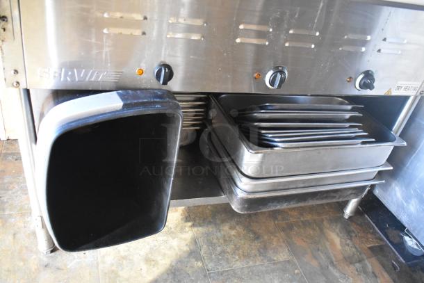 ServIt steam table with multiple pans and knobs in 2007 Lanchester food trailer. Includes storage and heating features.