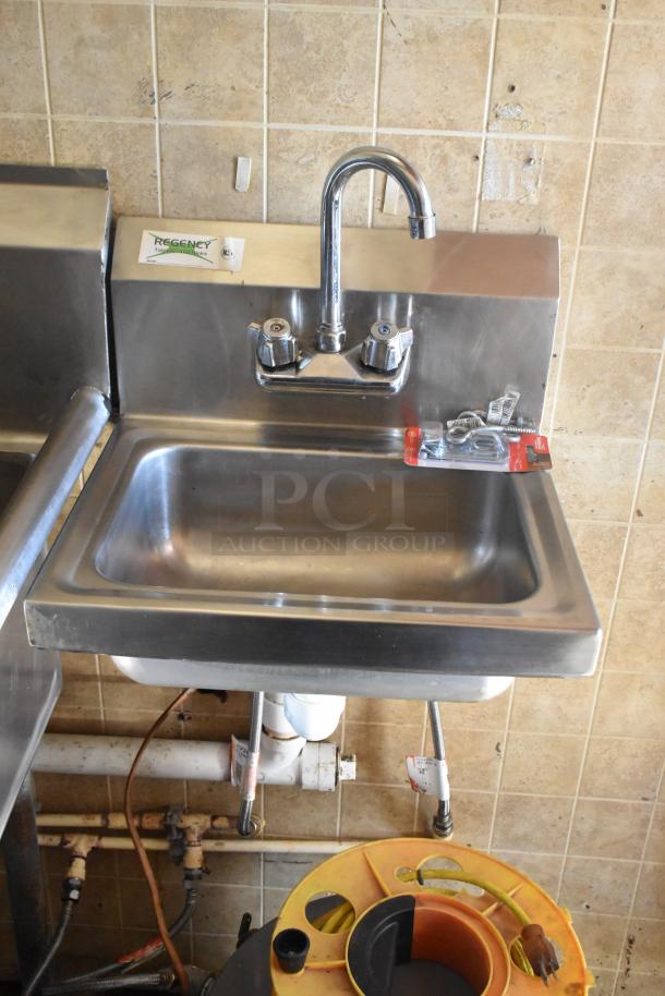 Stainless steel Regency sink in food trailer setup, with new fixtures and visible plumbing. Tile backsplash condition shows wear.