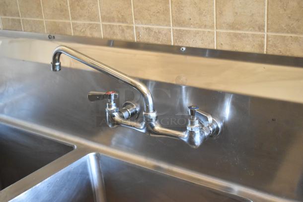 Stainless steel dual-compartment sink with wall-mounted faucet in 2007 Lanchester Food Trailer kitchen setup.