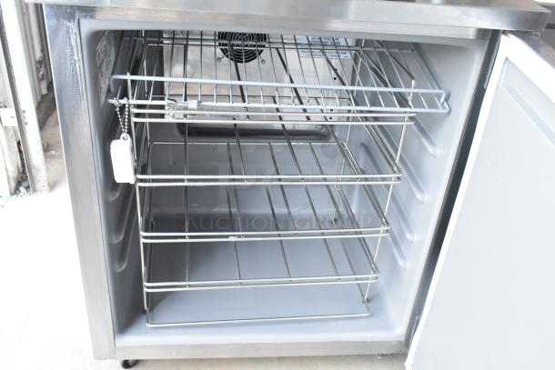 2021 Delfield 406P-STAR2 stainless steel undercounter cooler with open door, metal shelves, and casters. 115V, 1 phase.