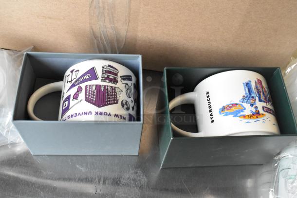Assorted Starbucks ceramic mugs in boxes; New York University and Brooklyn Bridge designs; excellent condition.