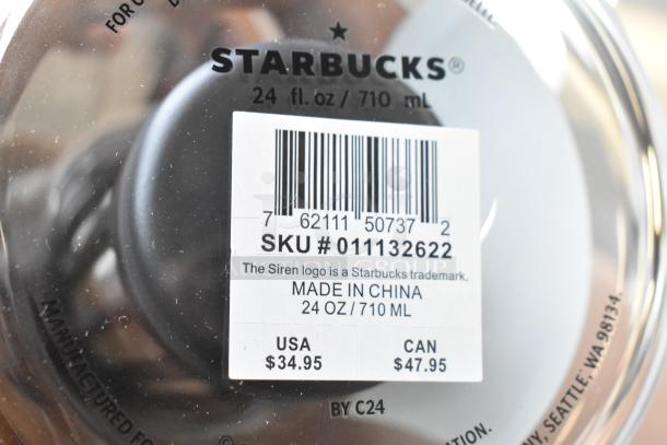 Close-up of Starbucks mug bottom showing label. SKU 011132622, 24 oz/710 ml. Made in China, priced at $34.95 USA/$47.95 CAN.