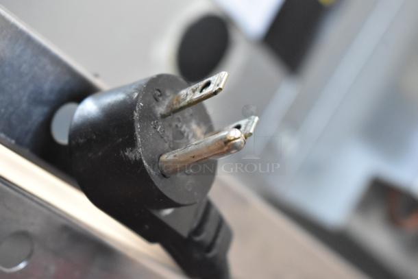 Close-up of a power plug for the 2019 Delfield 406P-STAR2 cooler, indicating its 115-voltage capacity.