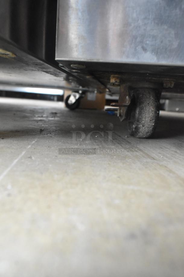 2019 Delfield 406P-STAR2 stainless steel undercounter cooler on commercial casters, 115V, single phase. Dust visible.