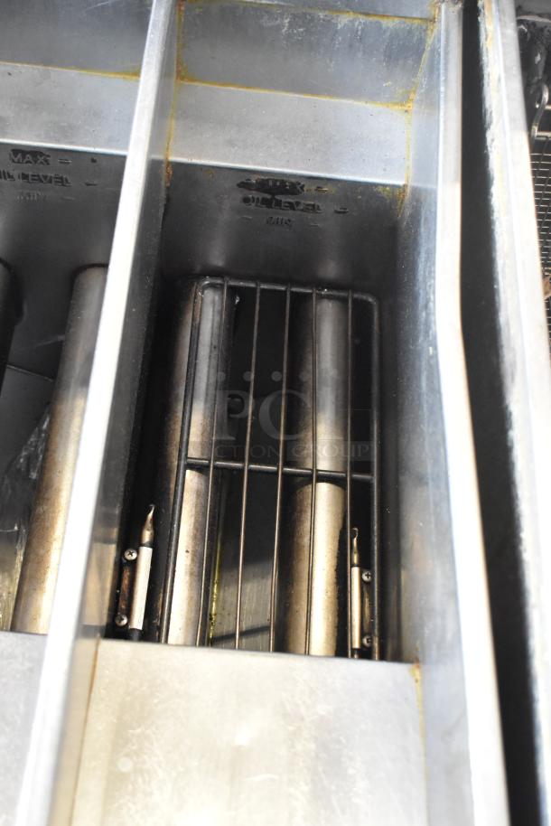 Pitco Frialator SG14T stainless steel deep fat fryer interior, showing heating elements and oil level markings.