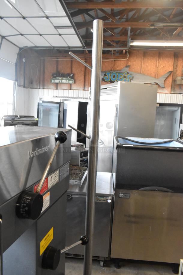 Stainless steel commercial mixer equipment stand with hanging rod, metal under shelf, on commercial casters; used condition.