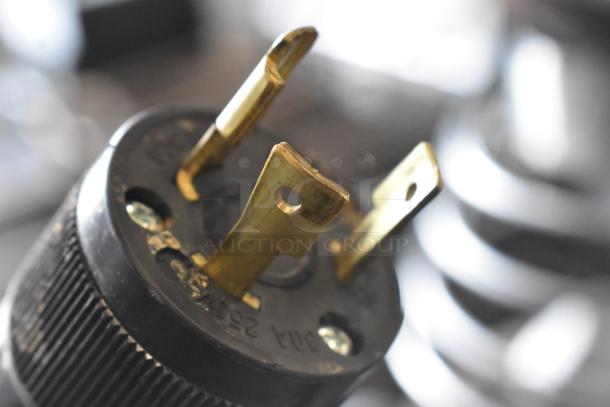 Close-up of a 208-240V plug for Schaerer Verismo 701 espresso machine, showcasing sturdy metal prongs.