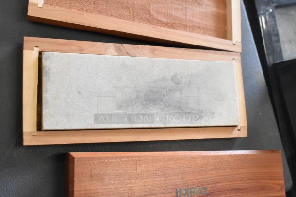 A gray rectangular stone slab in a wooden frame labeled “HOTTRIZ.”