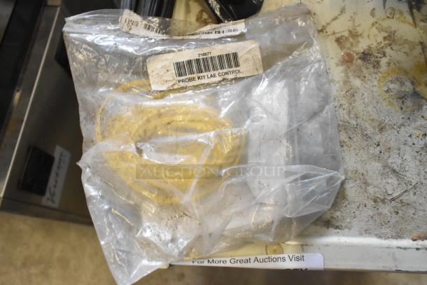 Clear plastic bag containing a yellow cord labeled "Probe Kit LAE Control" with visible barcode.