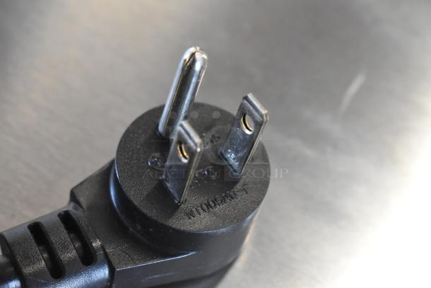 Close-up of a three-prong power plug for the 2021 Delfield 406P-STAR2 undercounter cooler, showing model marking.