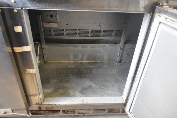 Beverage Air UCR72AY-23 undercounter cooler, stainless steel, three-door, on casters, visible wear inside, 115V, 1 phase.