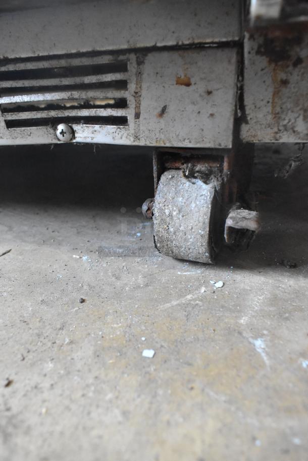 Beverage Air UCR72AY-23 cooler caster detail, showing signs of wear and rust. Model designed for commercial use.