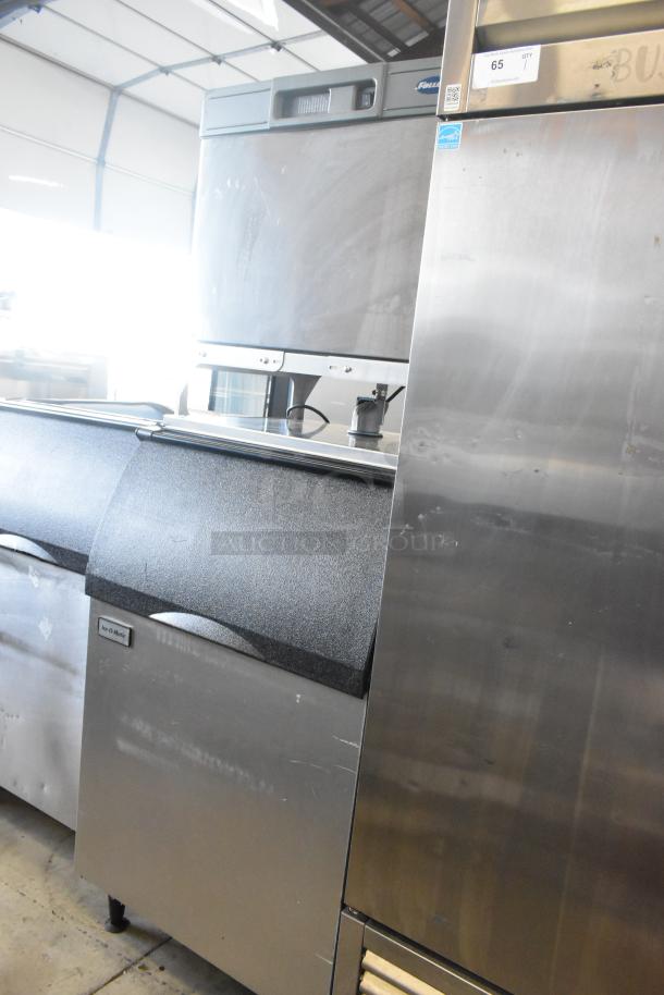 Follett B55H22H30 stainless steel ice head on Ice-O-Matic B55PSC bin. Visible wear; ideal for commercial use.