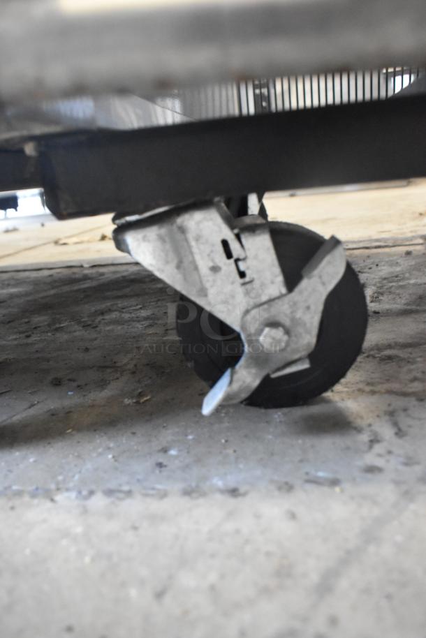 2019 True T-49F-HC stainless steel freezer caster, showing commercial wheel on concrete floor.