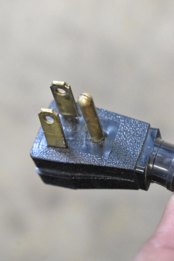 Close-up of a three-prong power plug for a 2019 True T-49F-HC commercial freezer, 115 volts, 1 phase.