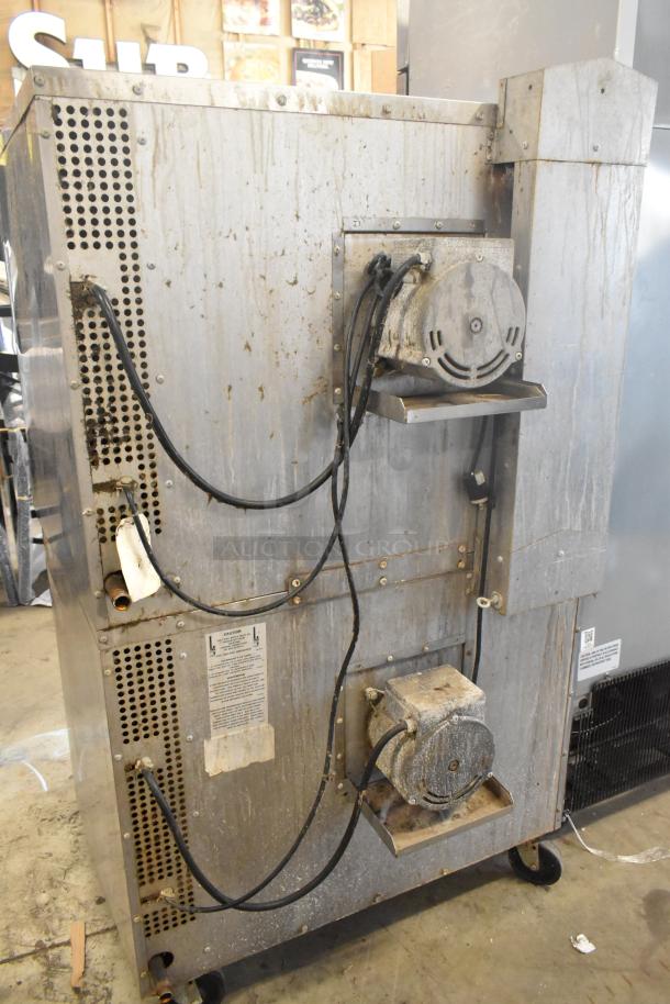 Two Southbend SL Series stainless steel commercial convection ovens on casters. Visible wear and dirt on exterior.