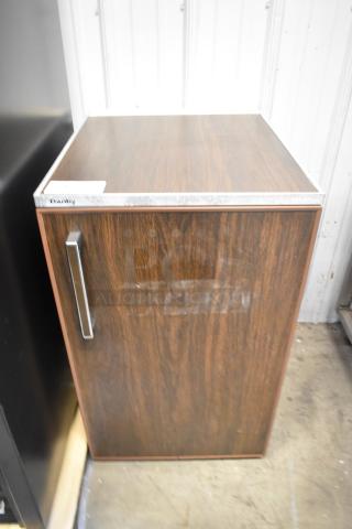 Danby Mini Cooler, wood finish. 115 volts, 1 phase. Features metal handle. Good condition. Danby label on top.