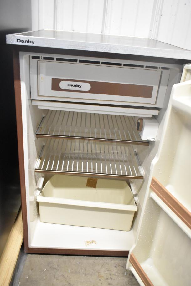 Danby Mini Cooler, 115 Volts, 1 Phase; features three wire shelves, freezer compartment, and door storage. Good condition.
