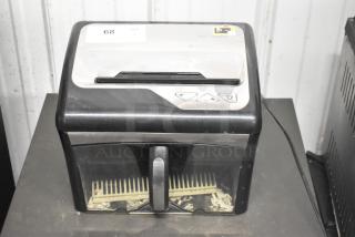 Staples SPL-TXC12MA countertop shredder, 120V, 1 Phase, in used condition. Features control buttons and visible paper bin.