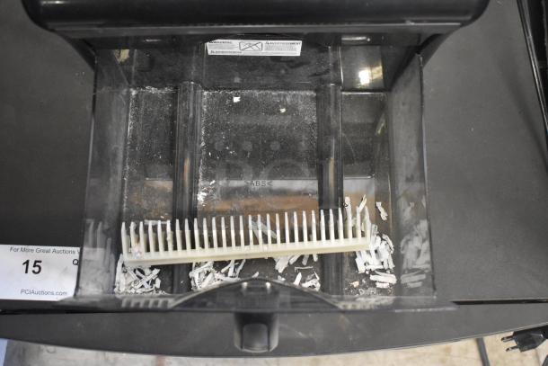 Staples SPL-TXC12MA countertop shredder, open bin with shredded paper, warning label visible, 120V, 1 phase.