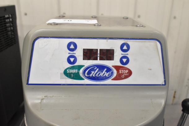 Globe SP40 dough mixer control panel with digital timer, start/stop buttons, visible usage marks.