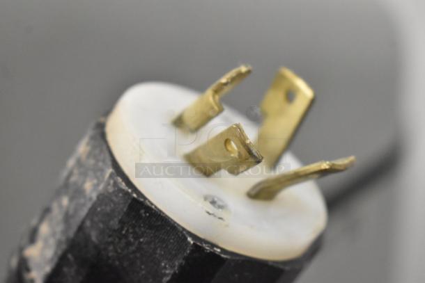 Close-up of a worn three-prong plug, part of the Globe SP40 mixer, showing signs of use.