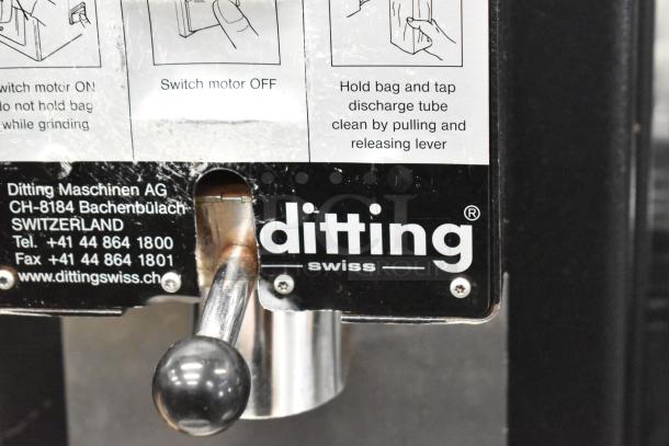 2017 Ditting KR1203 commercial coffee grinder, metal, 120 volts, visible label with usage instructions and contact details.