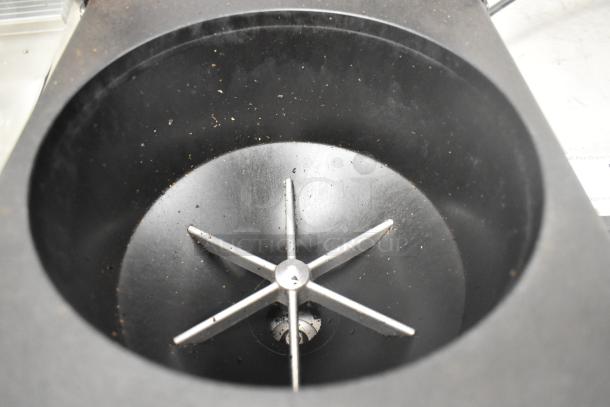 2017 Ditting KR1203 commercial coffee grinder's metal interior view showing burrs and slight coffee residue.