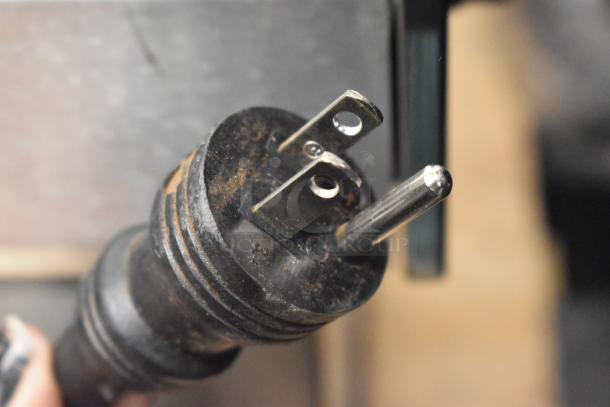 Close-up of a power plug from a 2017 Ditting KR1203 commercial coffee grinder. Fits standard 120-volt outlets.
