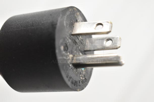 Close-up of a power plug for a 2021 Automatic Bar Controls JT-NITCOM-L Nitro Dispenser, showing prongs and markings.