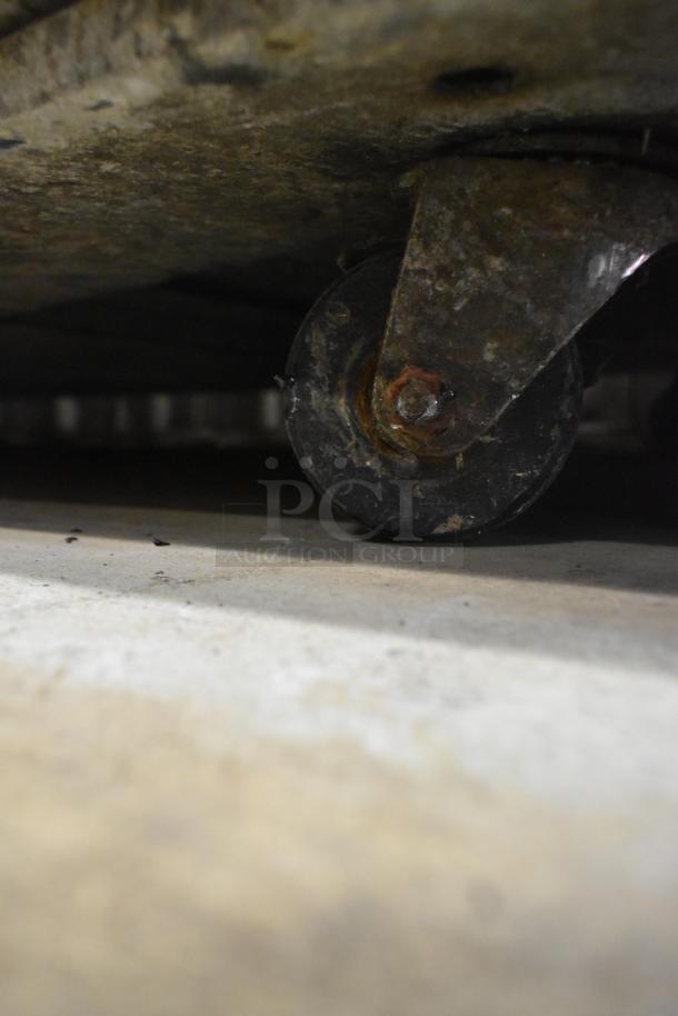 Rusty caster wheel on an undercounter cooler, indicating wear on the Beverage Air UCRD93A-4-23 model.