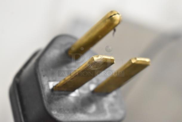 Close-up of the plug prongs for a 2022 Merrychef eikon e4 stainless steel rapid cook oven, 208/240 volts, 1 phase.