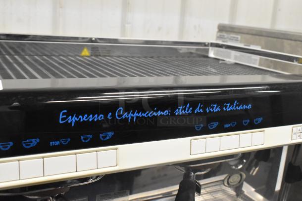 Faema Teorema 2 Group Espresso Machine, stainless steel, countertop model with 3 portafilters, 2 steam wands, in used condition.