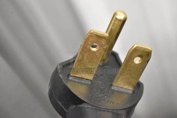 Close-up of a 208/240V, 1-phase power plug for the 2023 Merrychef eikon e2s rapid cook oven, showing metal prongs.