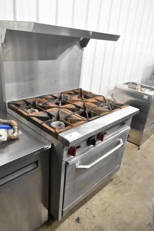 Vulcan SX36 stainless steel commercial gas range with 6 burners, oven, over shelf, and backsplash. 198,000 BTU.