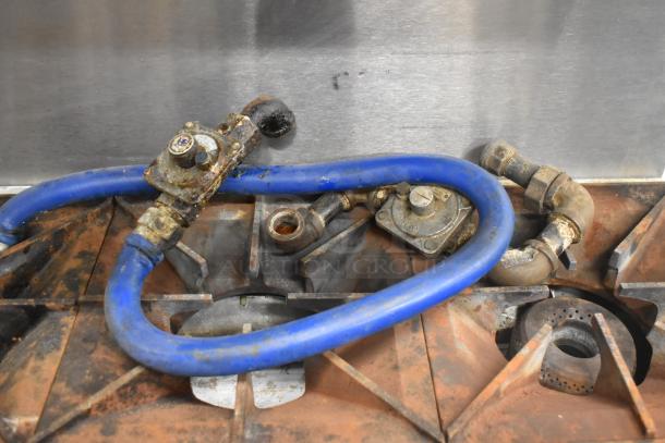 Rusty Vulcan SX36 gas-powered 6-burner range with blue hose. Commercial use, stainless steel, 198,000 BTU, needs cleaning.