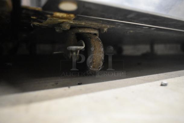 2019 Delfield 406P-STAR2 single door undercounter cooler, stainless, on commercial casters, 115V, showing caster detail.