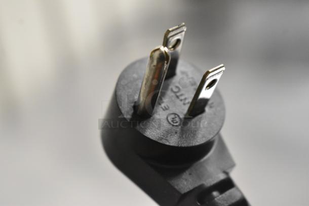 Close-up of a three-prong plug for a Delfield 406P-STAR2 commercial cooler, labeled 115 volts, 1 phase.