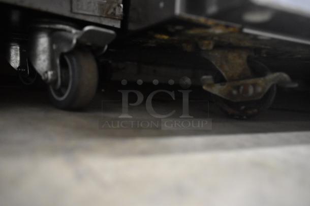 2019 Delfield 406P-STAR2 stainless steel undercounter cooler on commercial casters, 115V, single door, visible wheel detail.