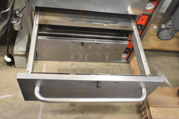 Vulcan stainless steel commercial warming drawer, 3 drawers, sturdy handle, visible wear, ideal for restaurant use.