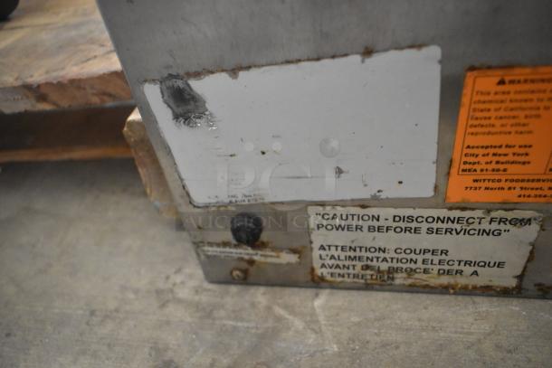 Vulcan stainless steel 3-drawer warming drawer. Features caution labels, signs of wear, and safety warnings visible.