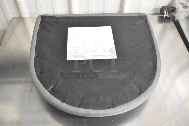 Gray seat cushion, new condition, lightly damaged, formaldehyde compliant tag visible, bid for 4 units.