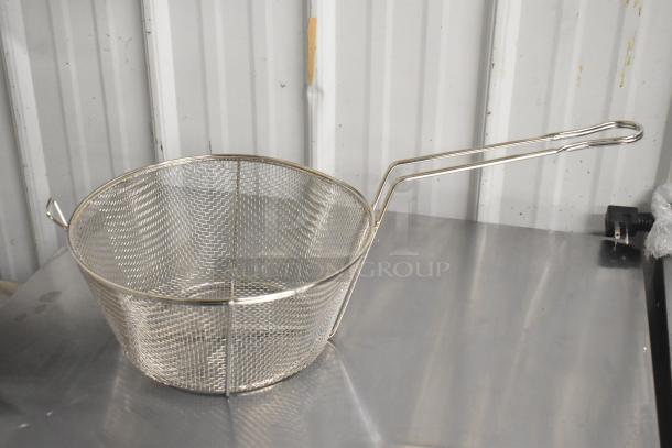 Stainless steel mesh basket with handle, new condition, slight scratches; ideal for kitchen use.