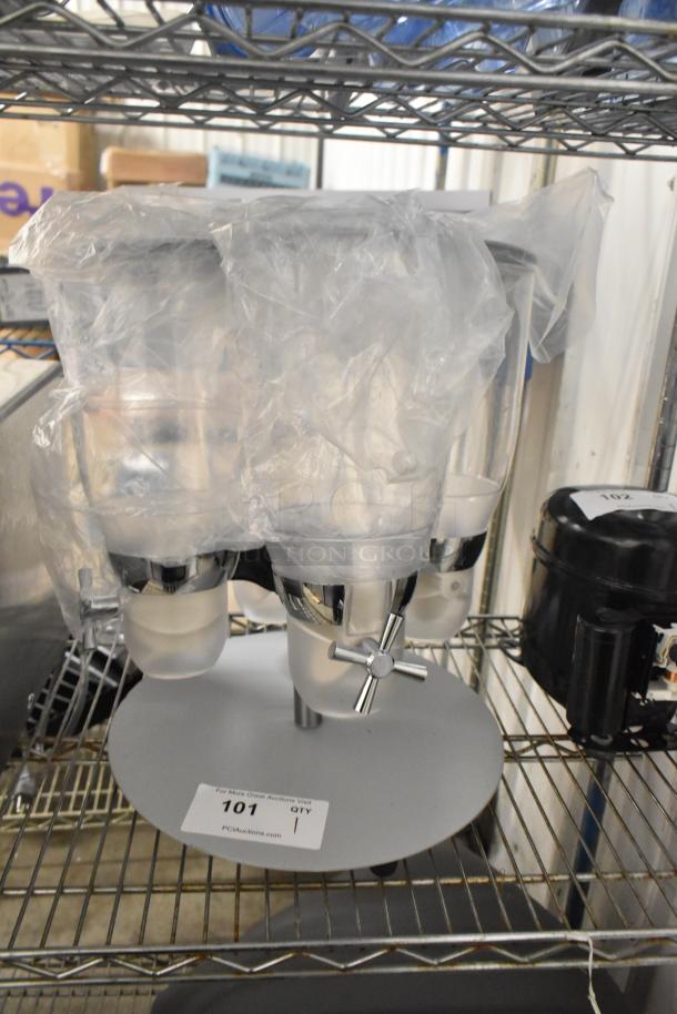 Brand new clear poly 4 hopper dry goods dispensing unit. One hopper has a crack. Wrapped with a protective plastic cover.