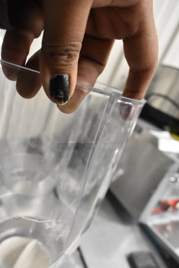 Clear poly 4 hopper dry goods dispenser, brand new with one cracked hopper. Scratch and dent condition.