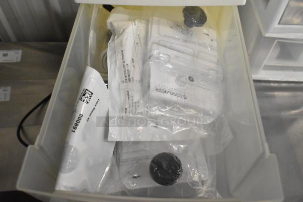 4 clear and white poly bins containing various sealed medical supplies, labeled "Starbucks Coffee Company" and "SERAFER."