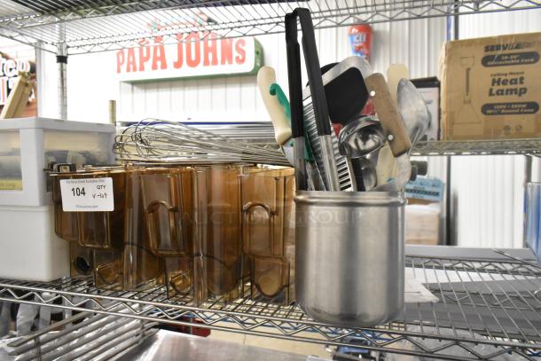 Lot of utensils and amber poly hoppers on a metal shelf. Includes whisks, spatulas, and various kitchen tools. Tag reads "104 QTY v-lot".
