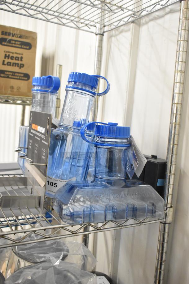 Six blue poly rapid cool bottles and drip tray on wire shelf. Bottles have blue lids and "Vigor Polar Paddle" marking. Auction lot 105.