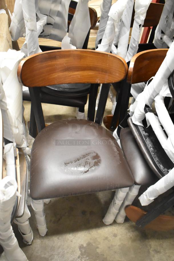 Black Lancaster chairs, metal frame with wooden back rest, wrapped for protection. New with visible scratches. 23 pieces available.